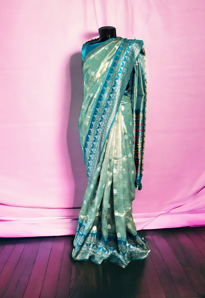 Pastel green paper tissue saree with zari border and pallu